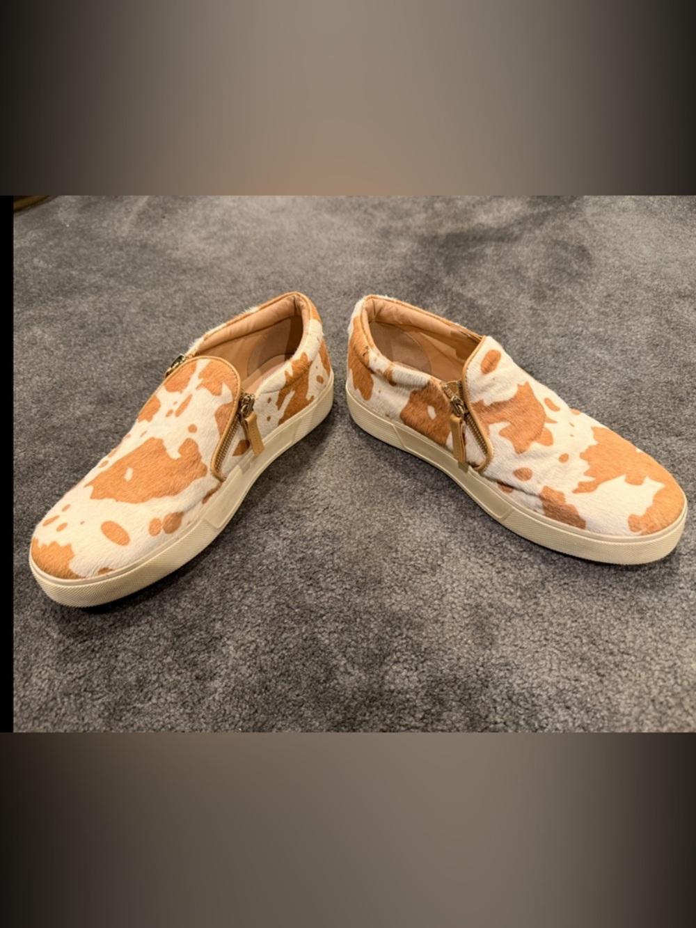 Very Volatile Cow Print Slip-On Sneakers in White and Tan